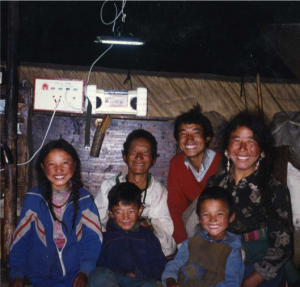 A family smiles under their new solar-powered light