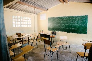 An empty classroom with desks and a chalkboard in Colombia