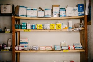 A wooden shelf filled with various medications