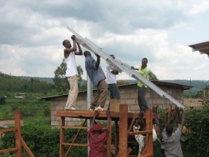 People build a structure to support solar panels in Rwanda