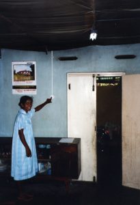 A woman turns on a light powered by solar energy