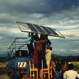 A group works together to install solar panels to electrify a community in Tanzania