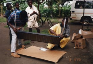 Two people assemble a solar panel in Uganda