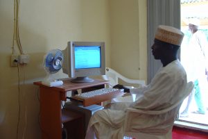 Man browses on a computer powered by solar energy in Jigawa State