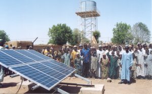 People stand behind a solar array