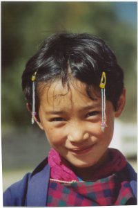 A child in Bhutan smiles at the camera