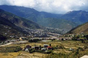 A city stretches along a valley in a mountainous Bhutan landscape