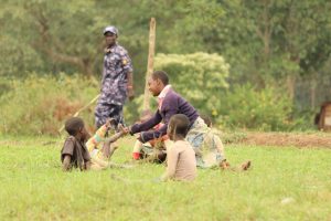 Children gather and play in a field at a Solar Electric Light Fund (SELF) site