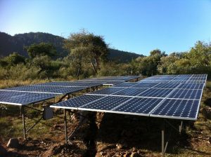 Solar array sits against a mountainous landscape in Kenya