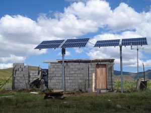 Two solar panels soak up the rays outside a cement structure in Lesotho