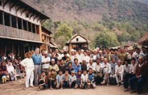 A large group of people gather for a photo in their village in Nepal