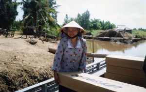 Woman in Vietnam helps transport boxes with new solar infrastructure