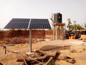 Solar panel with water tank and people standing in the background