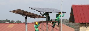 Solar technicians set up panels for a project electrifying health centers in Ghana and Uganda