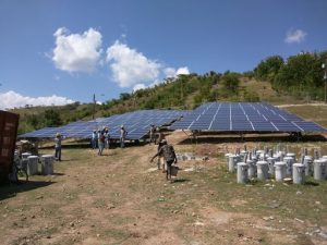 Team of people work to install a solar array in Haiti