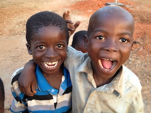 Two smiling children in Benin at a Solar Electric Light Fund (SELF) project site