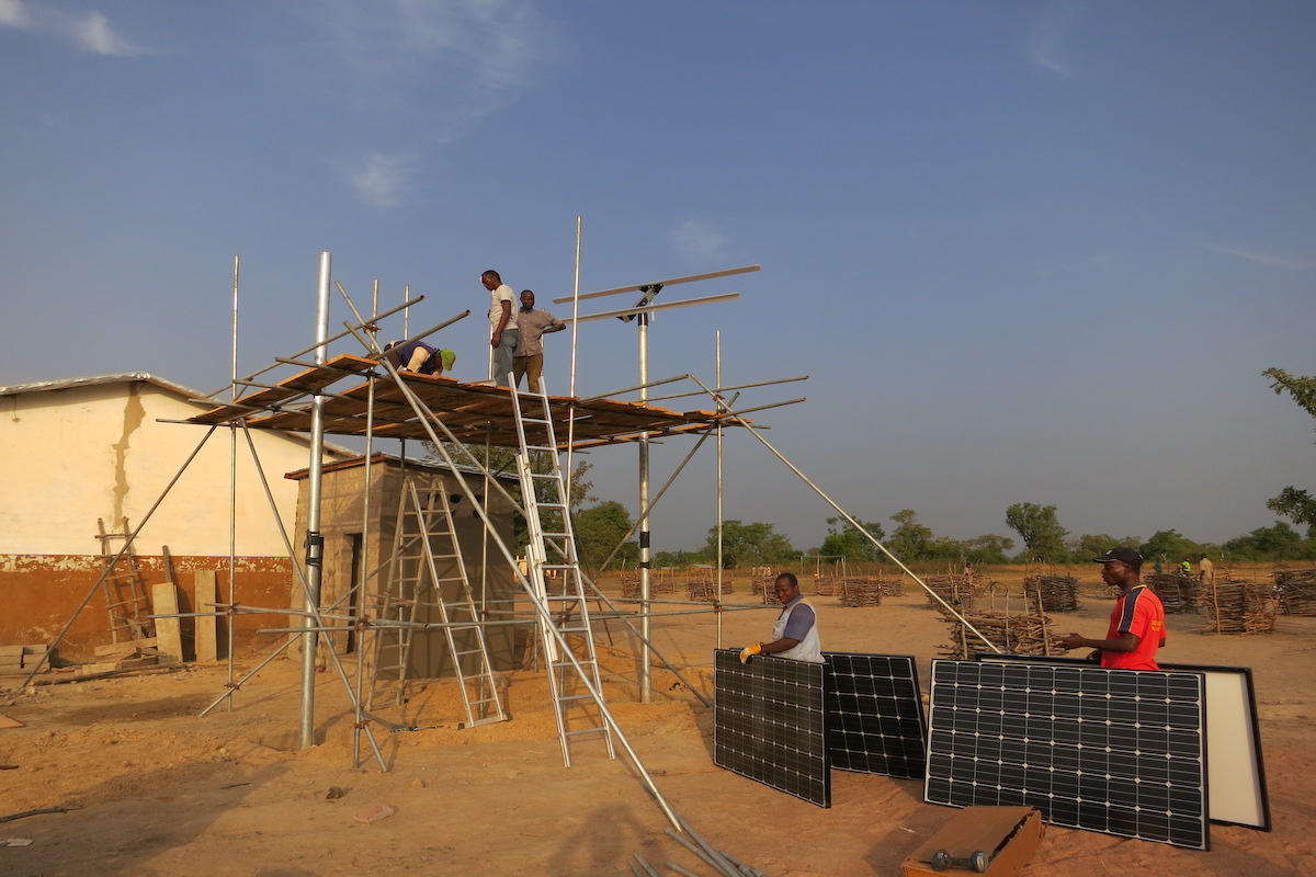 Solar panel installation in progress in a remote village