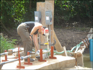 A SELF technician installs a solar water pump