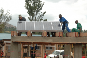 Technicians set up a solar array in a village