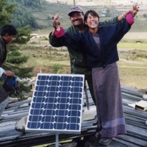 Two people in Bhutan celebrate the installation of a new solar panel