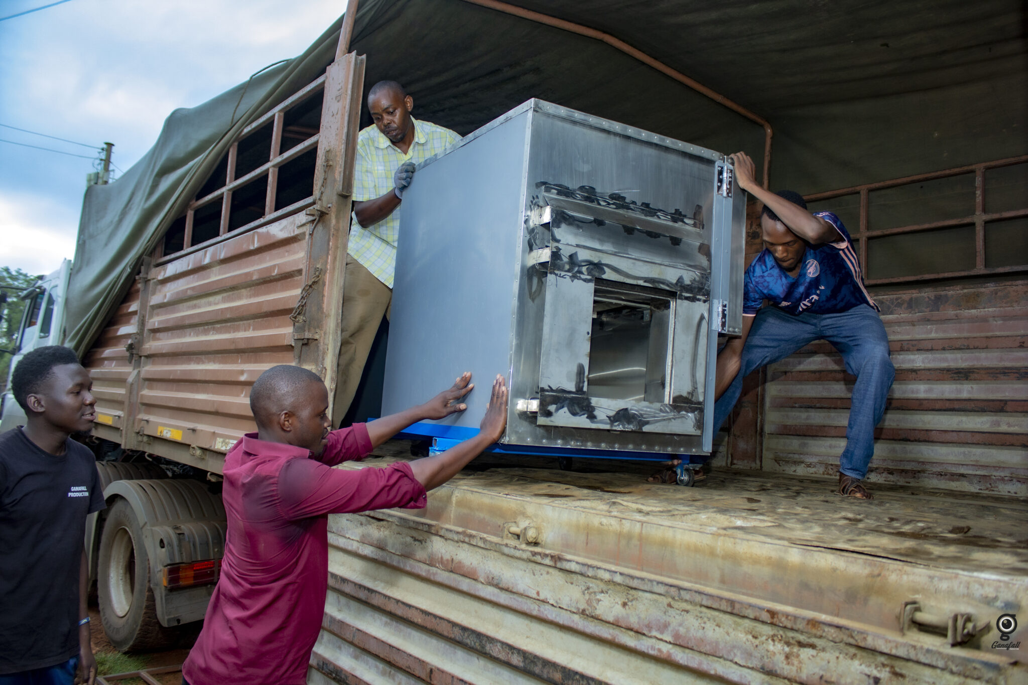A Lytefire solar oven is unloaded in Bukyerimba, Uganda for a Solar Electric Light Fund project with the Rape Hurts Foundation