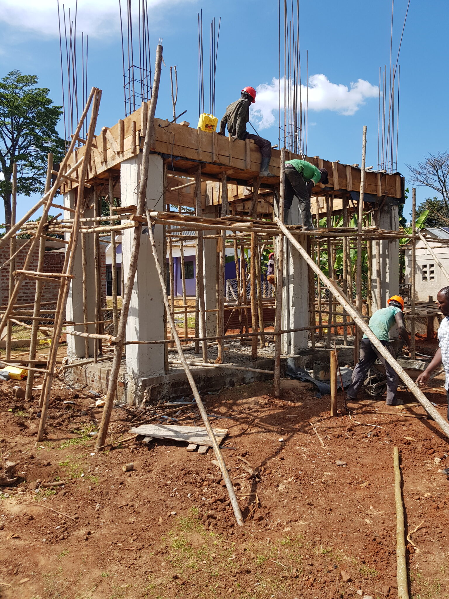 A construction team builds a structure that will house solar powered water pumps, part of a sustainable development initiative from the Solar Electric Light Fund
