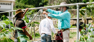 Two men set up a solar energy system as part of a sustainable development initiative in Colombia