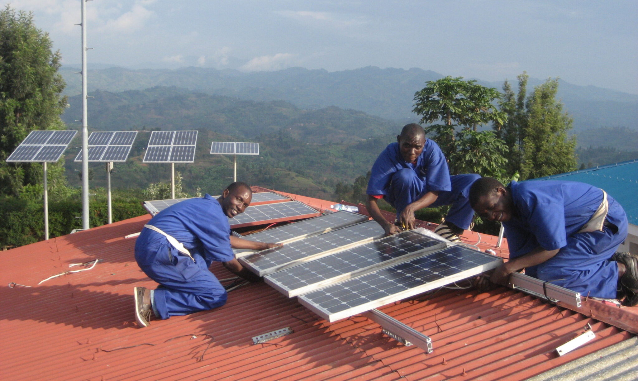 Technicians install rooftop solar panels as part of a rural energy access initiative.